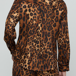 A person shown from the back wearing a leopard-print long-sleeve shirt and matching pants against a light gray studio background.
