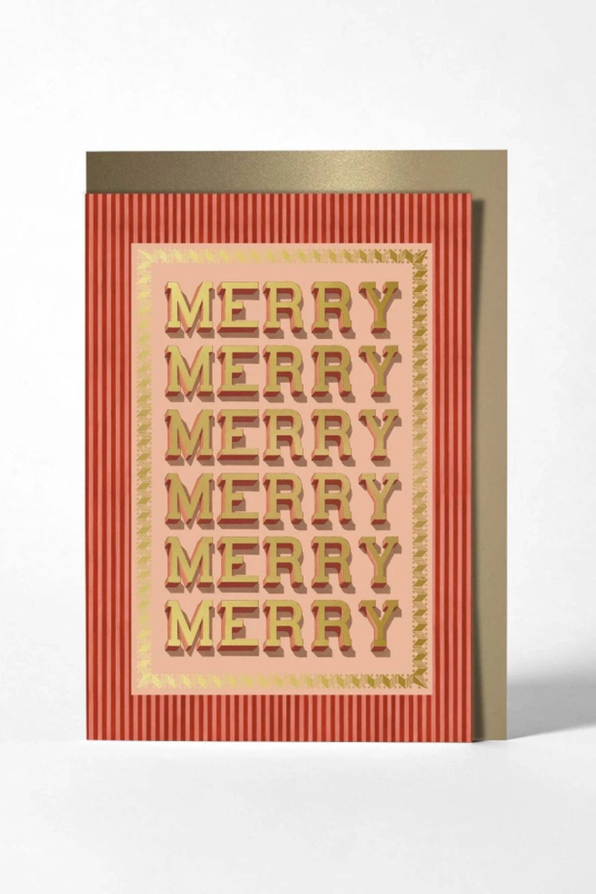 A festive greeting card with 'MERRY MERRY MERRY MERRY MERRY MERRY' printed in raised gold letters on a pale pink center panel, set against a red-and-gold striped border. A matching gold envelope is partially visible behind the card on a clean white background.