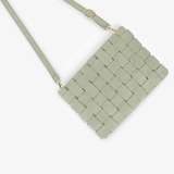 A woven leather crossbody bag in a muted sage green color, featuring a rectangular body and a matching shoulder strap, shown on a clean white background.
