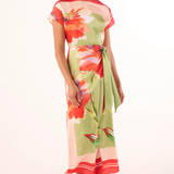 Woman wearing a colorful floral dress on a white background