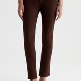 A model wearing dark brown skinny jeans and black pointed-toe heels, shown from the waist down against a plain white studio background.