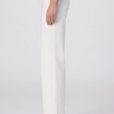 White pants worn by a person on a white background