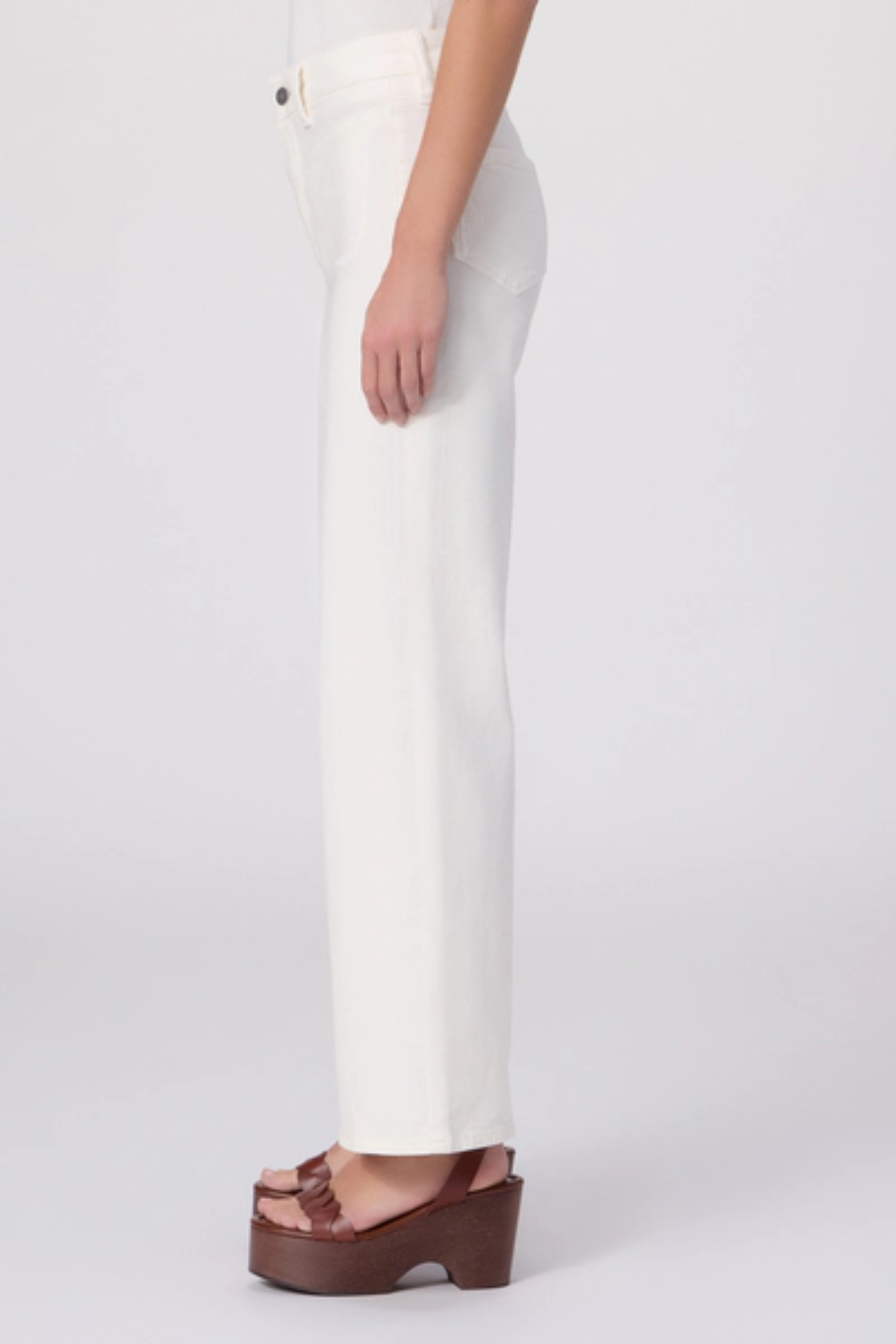 White pants worn by a person on a white background