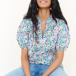 woman in floral blouse and denim on white background 
