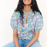 woman in floral blouse and denim on white background 