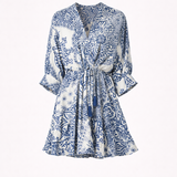 Blue and white patterned dress on a white background