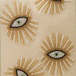 Embroidered eye designs on a beige fabric background