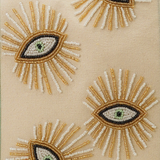 Embroidered eye designs on a beige fabric background