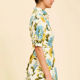 Woman wearing a floral dress on a beige background