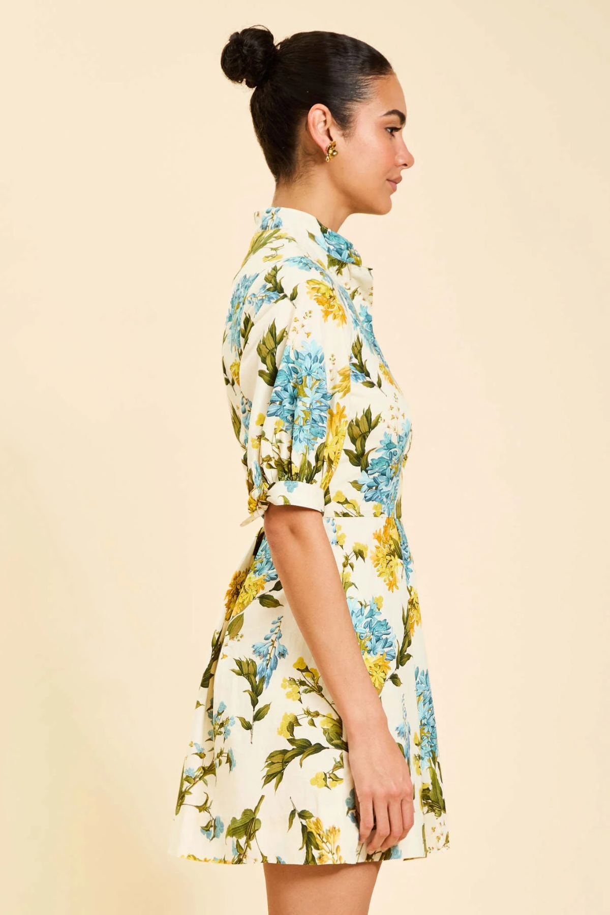 Woman wearing a floral dress on a beige background