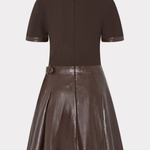 A dark brown two-piece outfit featuring a short-sleeve ribbed knit top and a matching pleated faux-leather skirt, shown against a light gray background.