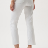 White cropped jeans shown from the back on a model, paired with black kitten-heel sandals against a clean white studio background.
