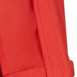 Close-up of a red jacket with a button on a white background
