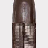 A dark brown faux-leather and mesh skirt with a matching belt, shown on a model wearing brown knee-high boots against a light gray background.