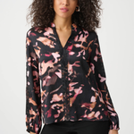 Woman wearing a floral blouse with a white background