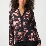 Woman wearing a floral blouse with a white background