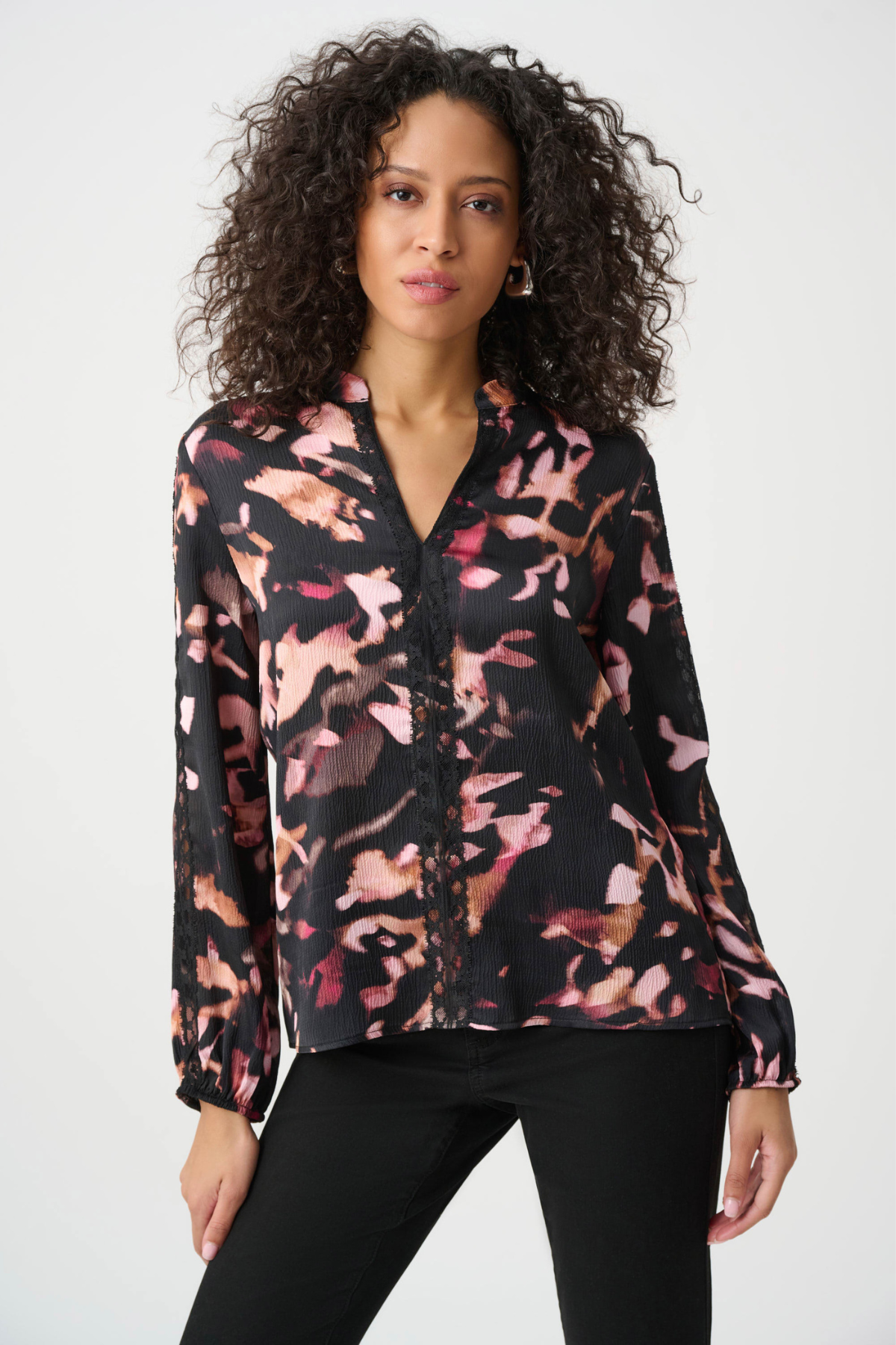Woman wearing a floral blouse with a white background