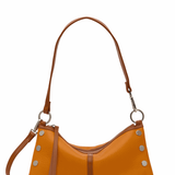 Brown leather handbag with studs on a white background