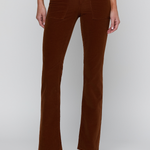 A model wearing brown corduroy flare pants with a matching brown vest and black heeled sandals, shown from the waist down against a light gray studio background.