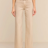 A model wearing beige wide-leg cropped pants with a tan belt and a gold buckle, paired with an olive green top and green suede boots, against a solid beige background.