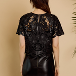 Black lace dress on a beige background
