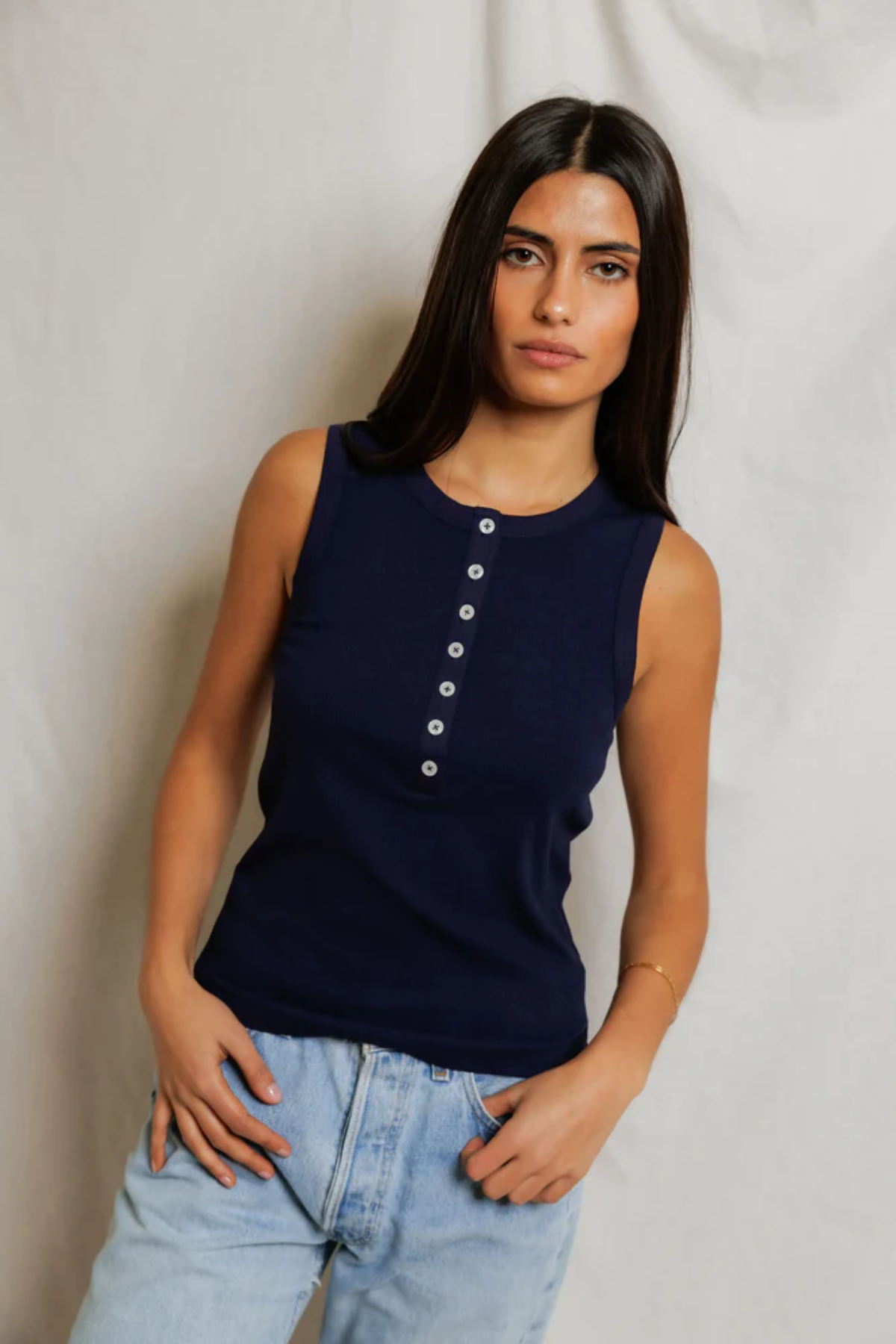 woman  in navy sleeveless top 