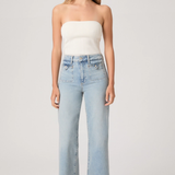 Woman wearing a white strapless top and light blue jeans on a plain background