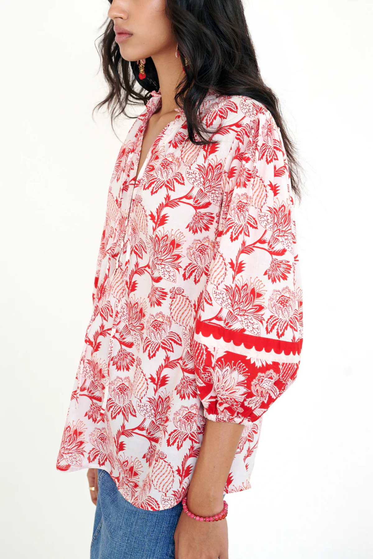 red printed long sleeve blouse  modeled against a white background