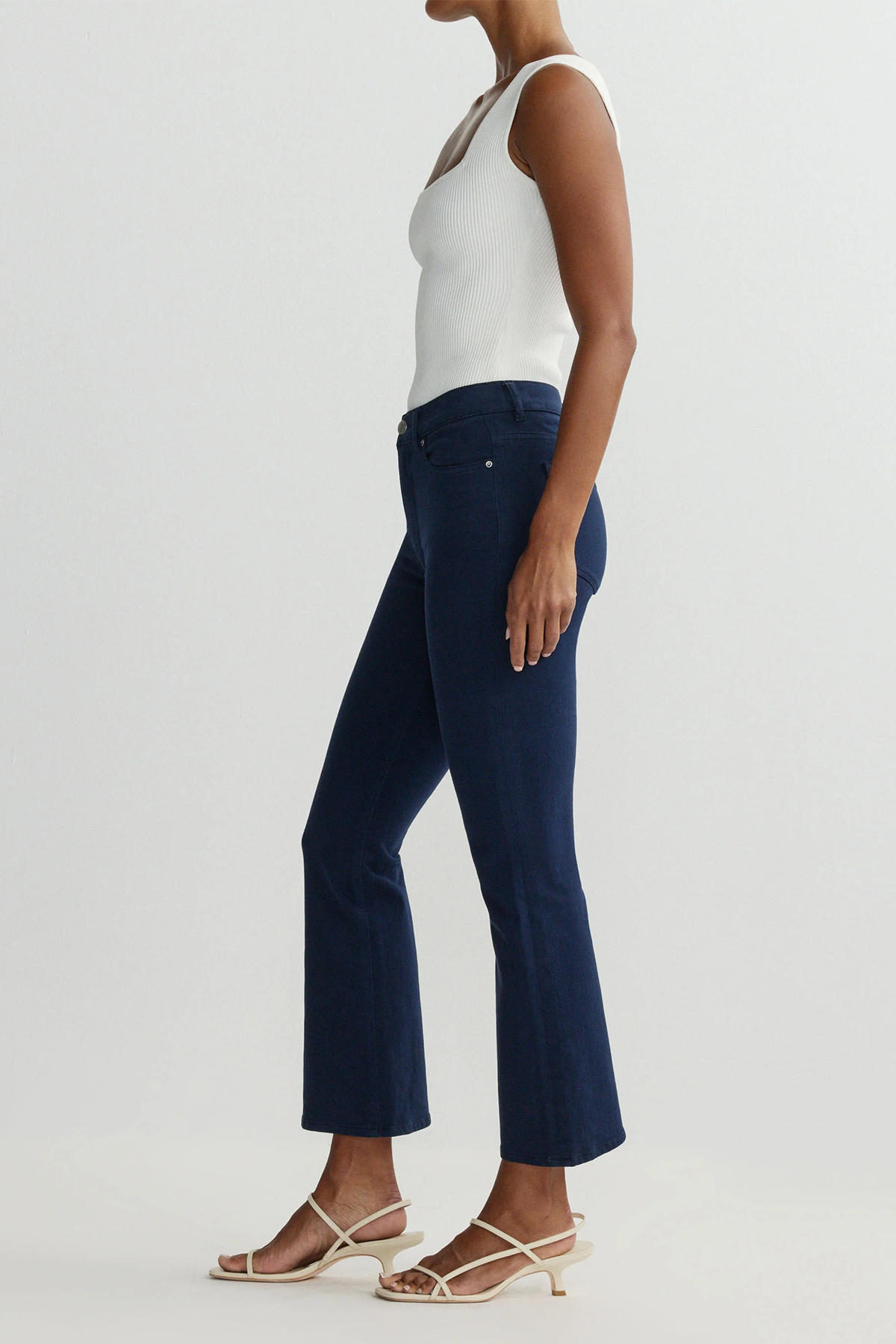 side view of navy pants on white background