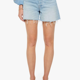 Person wearing light blue denim shorts on a white background