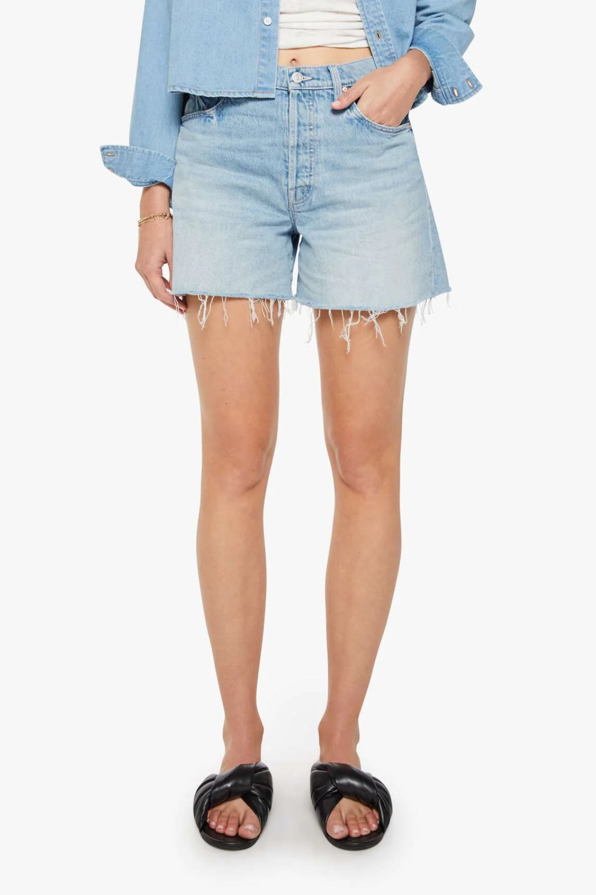 Person wearing light blue denim shorts on a white background