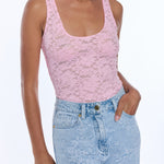 woman in pink lace tank top and denim 