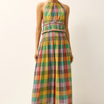 Woman wearing a colorful plaid dress on a white background