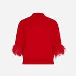 A bright red knit sweater shown from the back, featuring feathered trim at the cuffs, set against a solid light gray background.