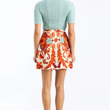 Woman wearing a soft mint cable knit sweater with a smooth, lightweight knit and polished neckline