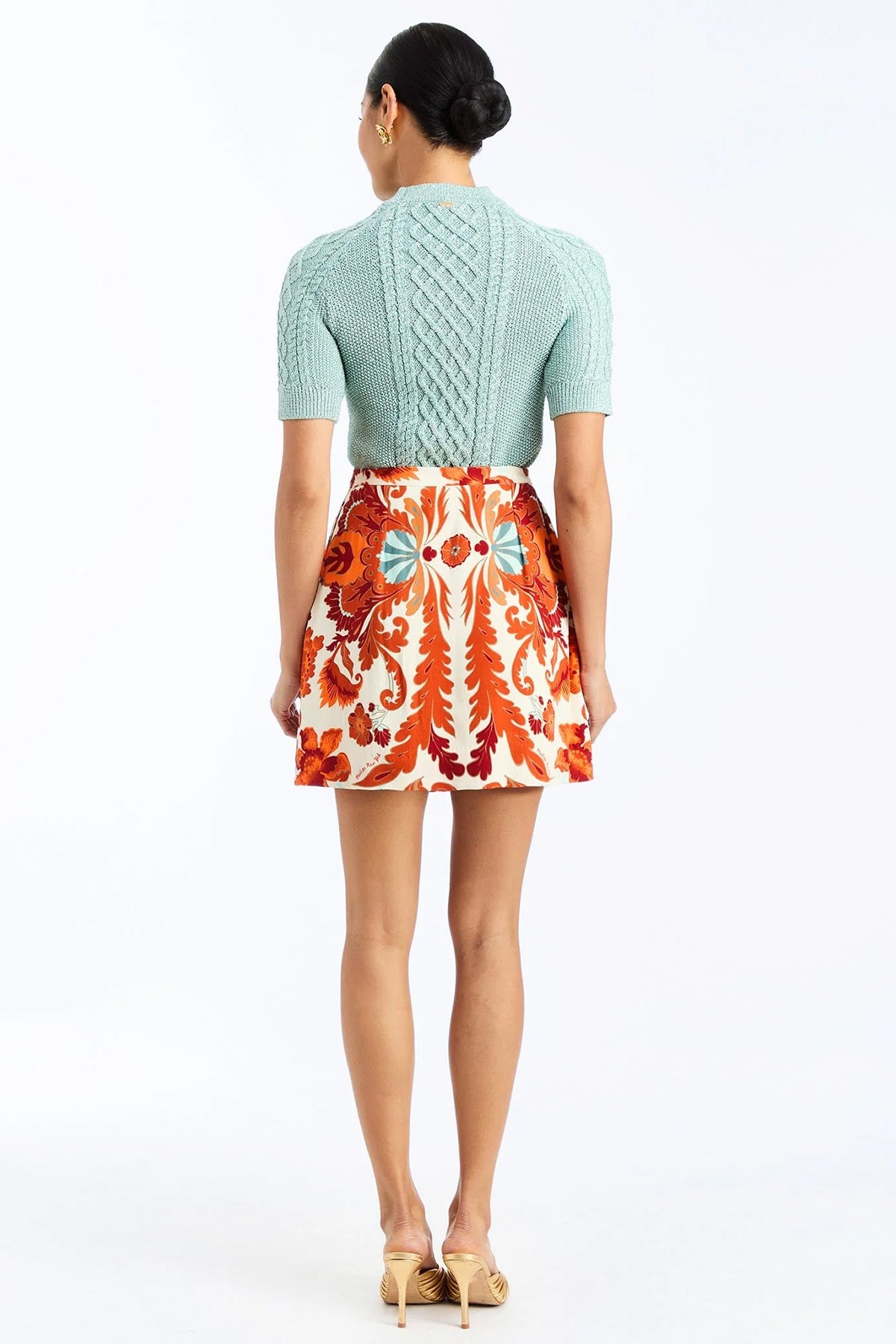 Woman wearing a soft mint cable knit sweater with a smooth, lightweight knit and polished neckline