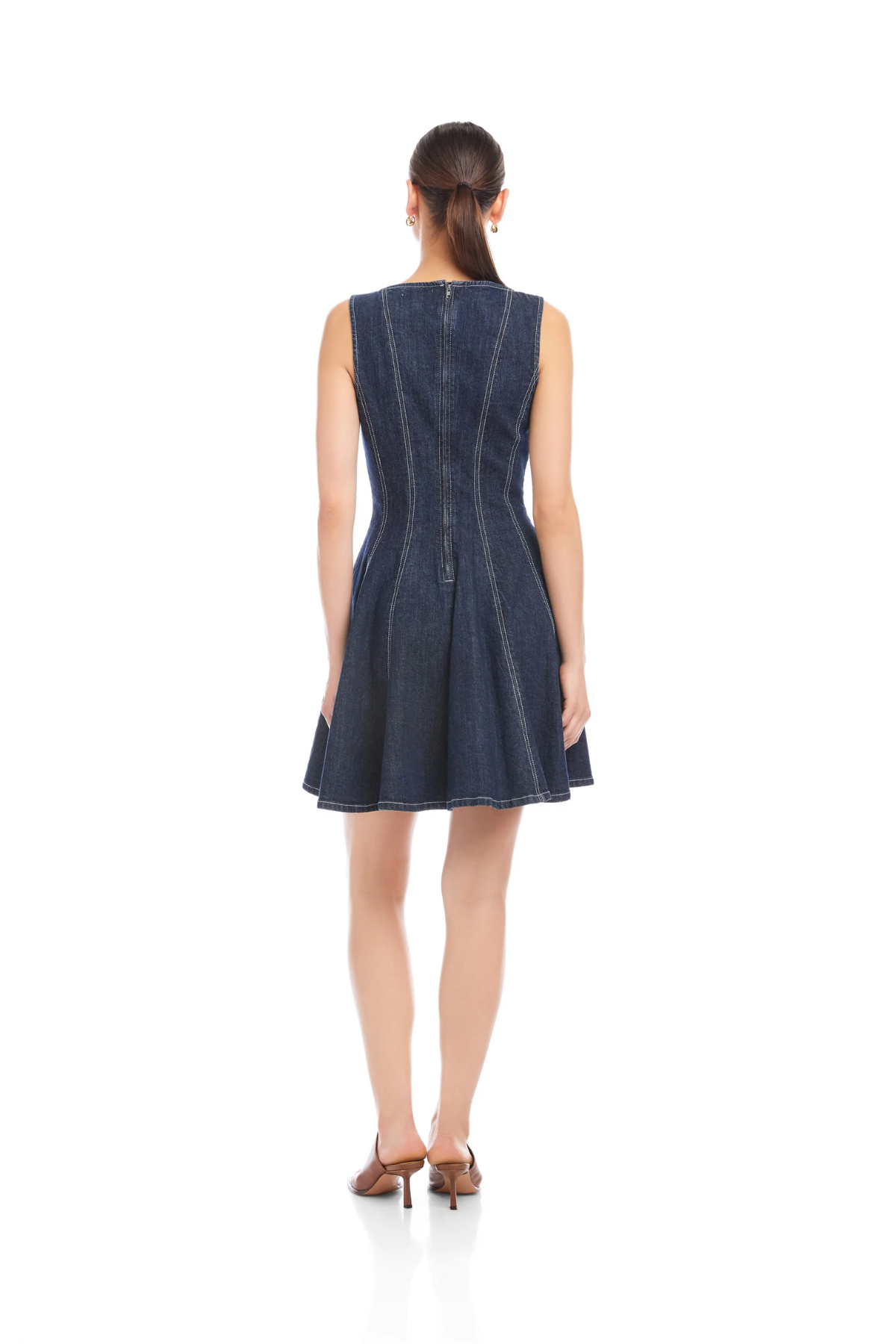 Woman wearing a denim dress on a white background