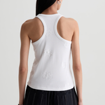 Model wearing a versatile solid-color top with a flattering silhouette styled with tailored black pants.