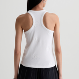 Model wearing a versatile solid-color top with a flattering silhouette styled with tailored black pants.