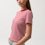 Woman wearing a red and white striped t-shirt against a plain background