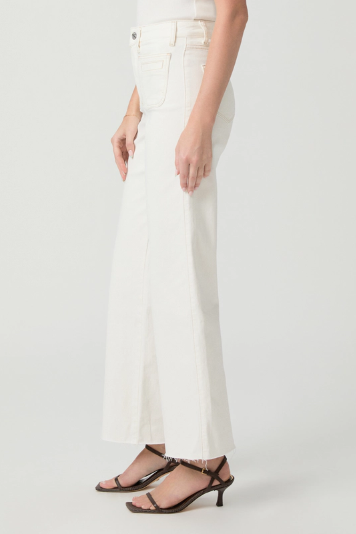 White pants worn by a person on a white background