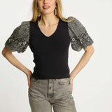 Black short-sleeve top with a clean neckline and soft drape
