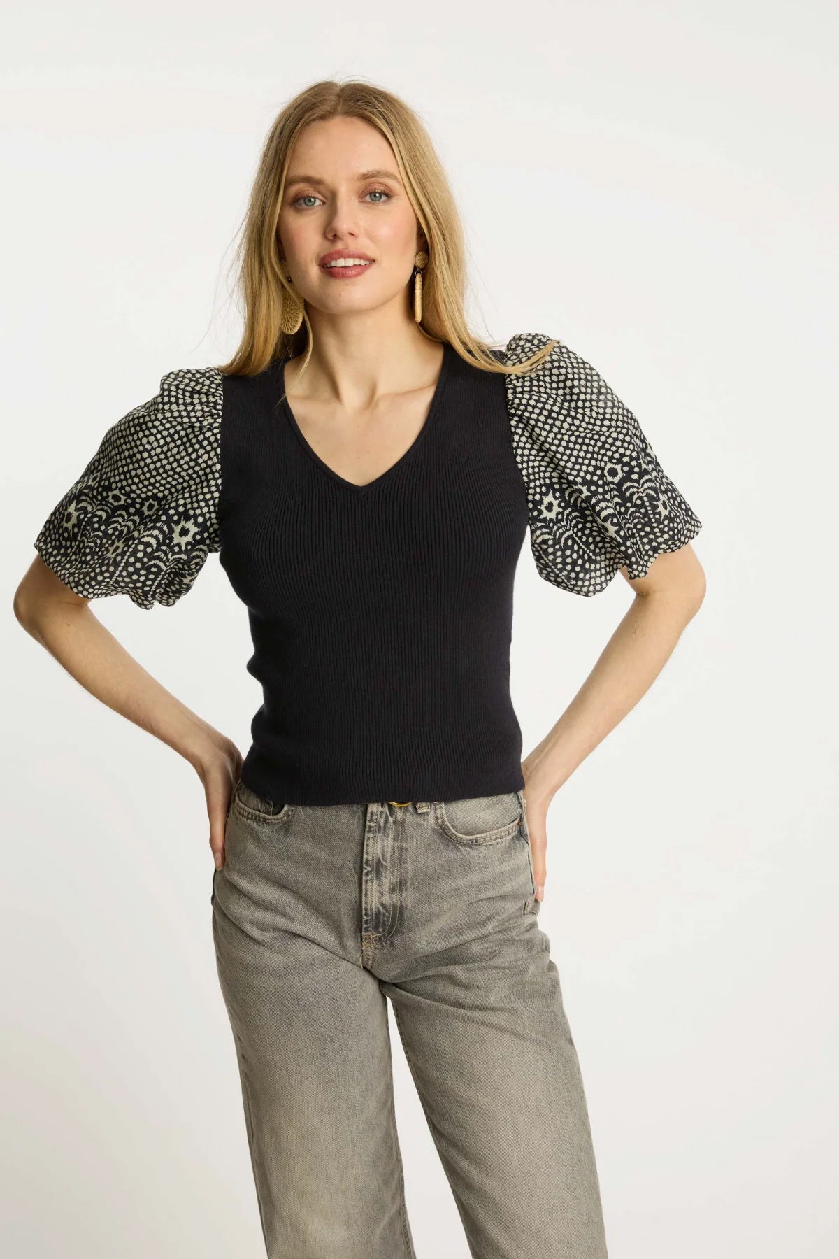 Black short-sleeve top with a clean neckline and soft drape