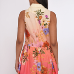 Woman wearing a colorful floral dress with a white background