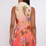Woman wearing a colorful floral dress with a white background