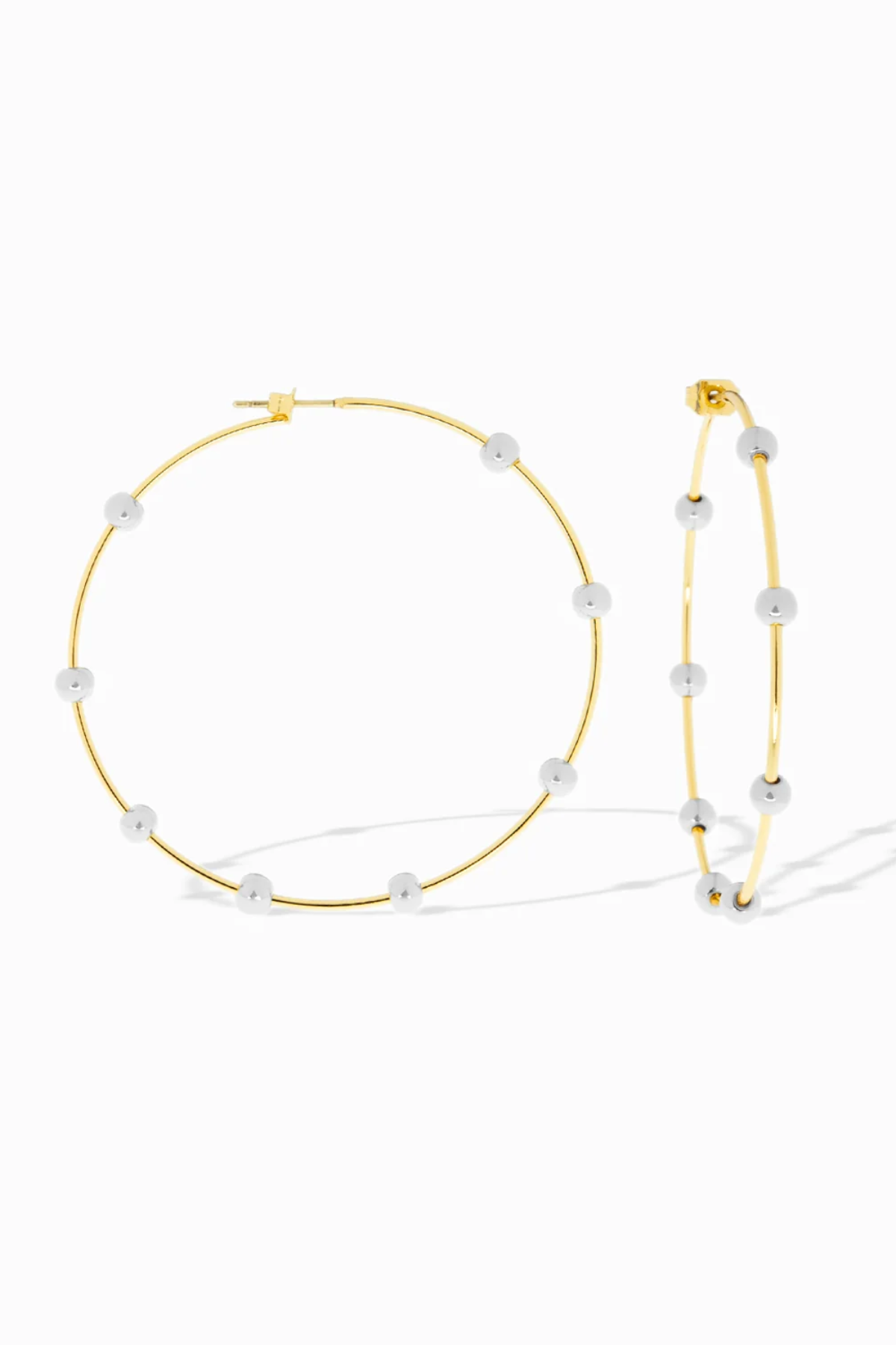Gold hoop earrings with pearl-like beads on a white background