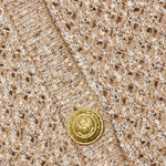 Close-up of a textured fabric with gold buttons