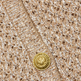 Close-up of a textured fabric with gold buttons
