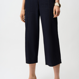 Navy blue wide-leg pants worn by a person on a white background
