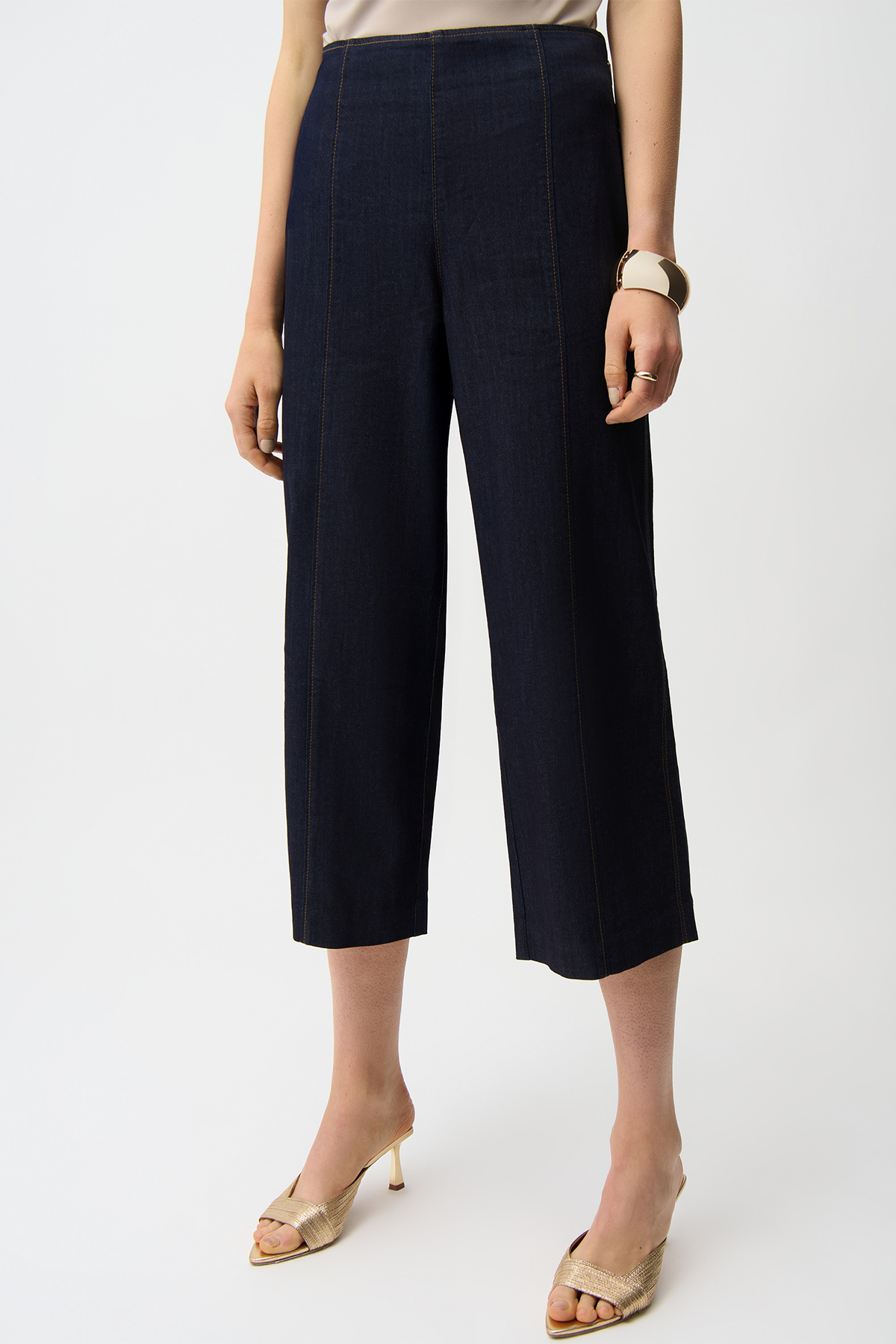 Navy blue wide-leg pants worn by a person on a white background